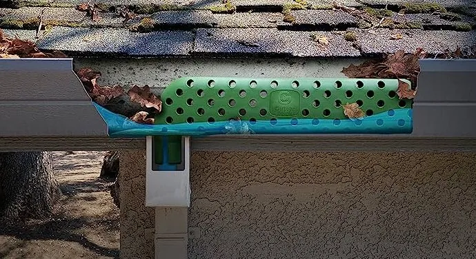 A Gutter Stick high-tech downspout filter installed at the gutter outlet